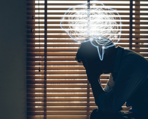 depressed man sitting head in hands on the bed in the dark bedroom with low light environment and and Polygonal brain shape with tangle doodle, Depress and stressed concept