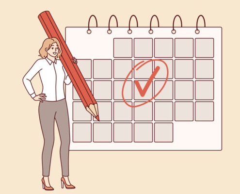 Woman engaged in annual planning and uses a calendar to keep a schedule, standing with a large pencil in hand.